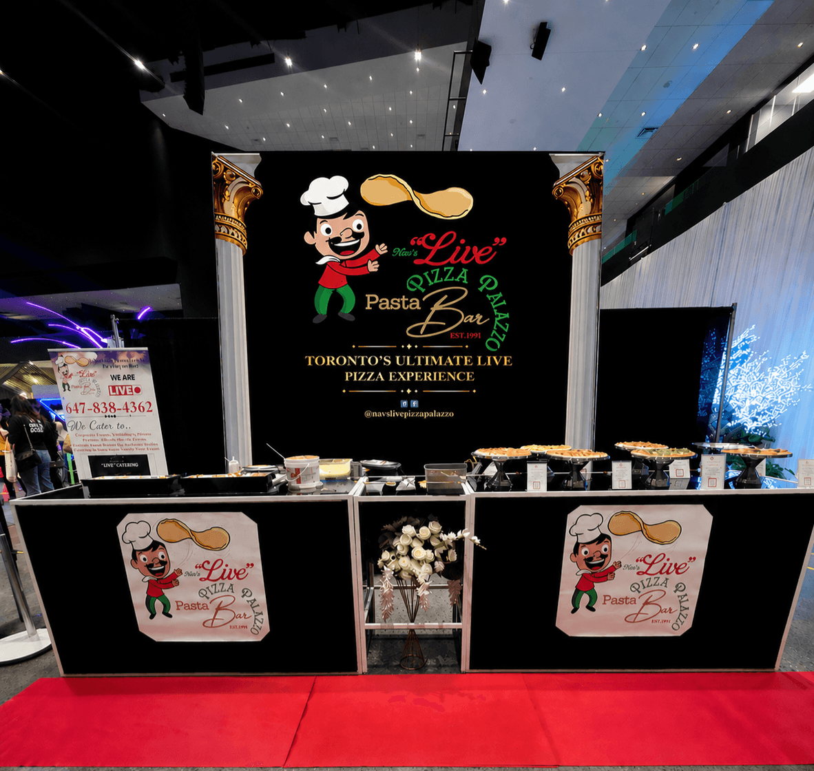 Branded Live Pizza Palazzo booth with gold columns and a red carpet at a corporate showcase