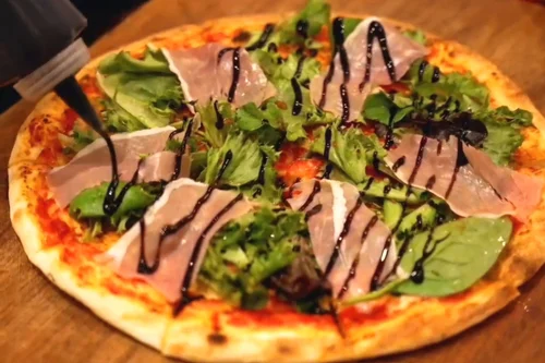Prosciutto and arugula pizza with balsamic glaze